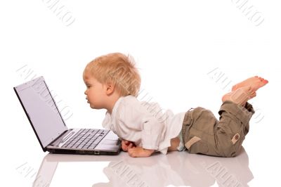 Young boy looking at a laptop