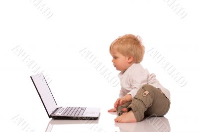 Young boy looking at a laptop