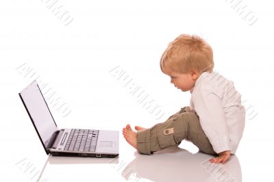 Young boy looking at a laptop