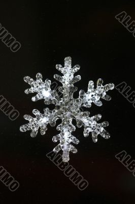 Christmas snowflake decoration on black background 
