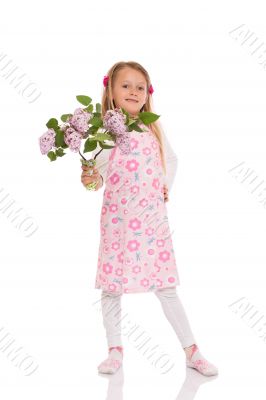 Smiling little girl with lilac flowers