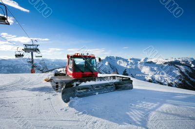 Snow-grooming machine on snow hill 