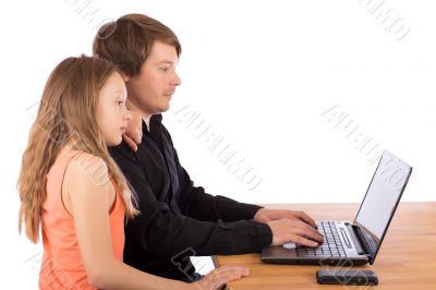 Father working with his daughter on a laptop