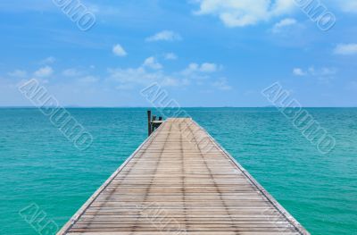 Wooden footbridge over the water near the beach 