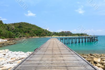 Wooden footbridge over the water near the beach 