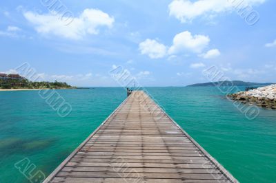 Wooden footbridge over the water near the beach 