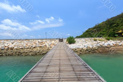 Wooden footbridge over the water near the beach 