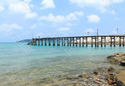 Wooden footbridge over the water near the beach 