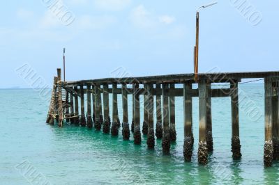 Wooden footbridge over the water near the beach 