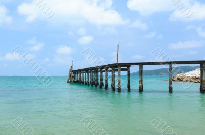 Wooden footbridge over the water near the beach 