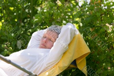 Mature woman sleeping on lounger