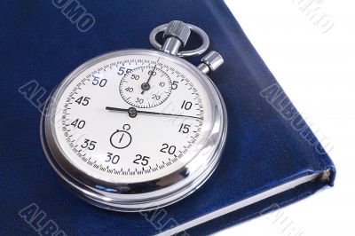 Stopwatch and the notebook on a white background