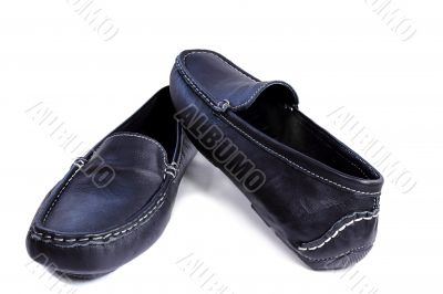Black leather loafers on a white background.