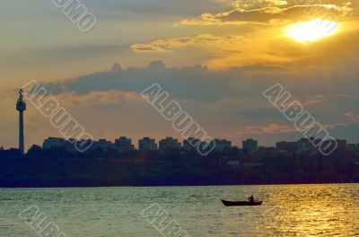fishermen in boat at sunset