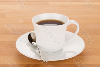 Cup of coffee and silver spoon
