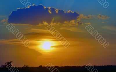 beautiful sunset above green filed