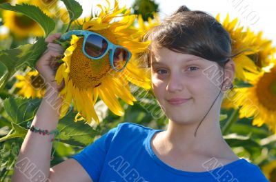 Young beautiful girl in a sunflower field
