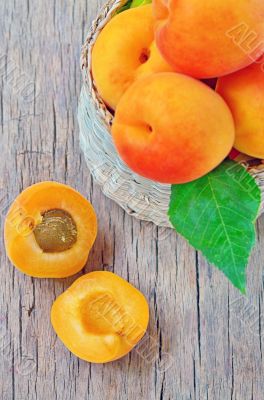fruits apricot in basket on wooden background