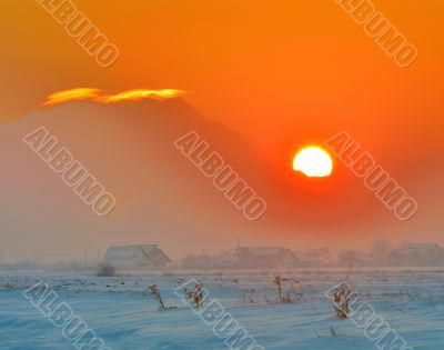 sunset over village