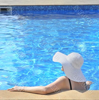 Woman sitting in a swimming pool