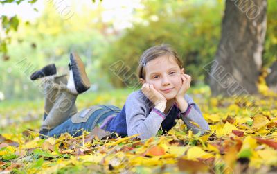 little girl  laying on the grass