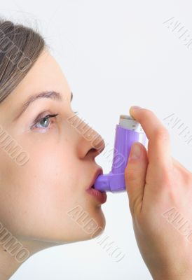 girl using an inhaler for Asthma