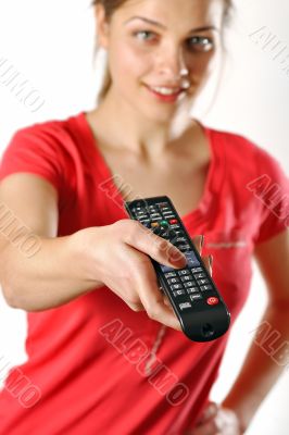 young girl watching tv using a remote control
