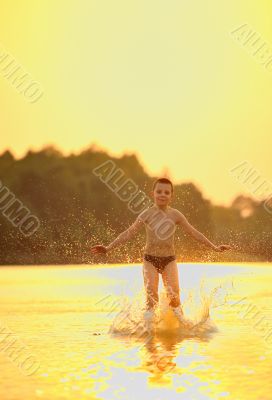 boy jumping in river