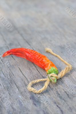 Red chili peppers over wooden background 