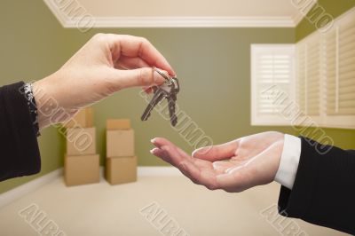 Woman Handing Over the House Keys Inside Empty Green Room