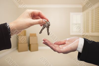 Agent Handing Over the House Keys Inside Empty Tan Room