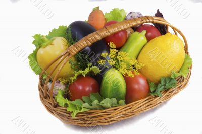Basket with fruits and vegetables , photographed on a white back