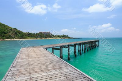 Wooden footbridge over the water near the beach 