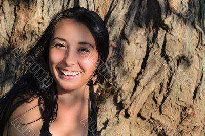 The girl near a tree trunk