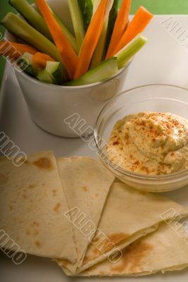 hummus dip with pita bread and vegetable