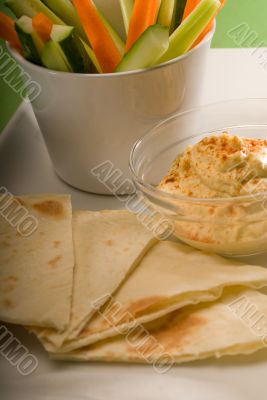 hummus dip with pita bread and vegetable