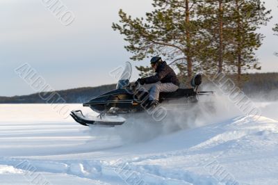 man riding a snowmobile