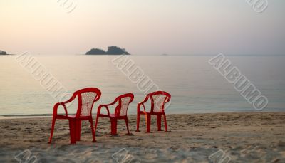 Empty beach three chair `watching` ; the sunset