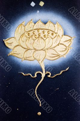 golden flower painted on a dark canvas