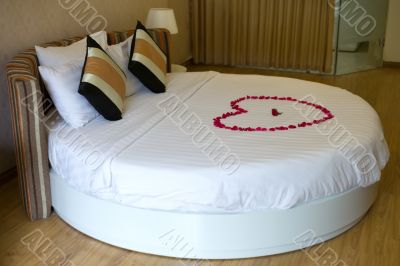 Honeymoon bed topped with rose petals