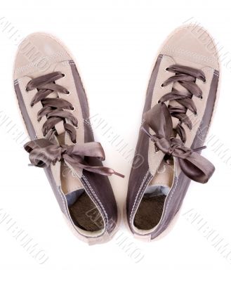 pair of fashionable sneakers on a white background. View from ab