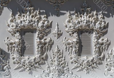 windows in the building of the White Temple in Chiang Mai
