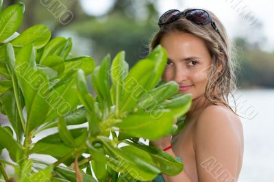 Portrait of young beautiful woman getting through the jungle