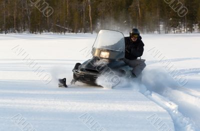 man riding a snowmobile