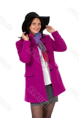 Cheerful girl in a coat and hat
