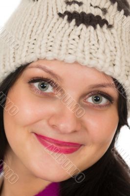 Portrait of a beautiful brunette in a warm hat