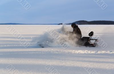man riding a snowmobile