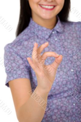 smiling girl showing OK sign