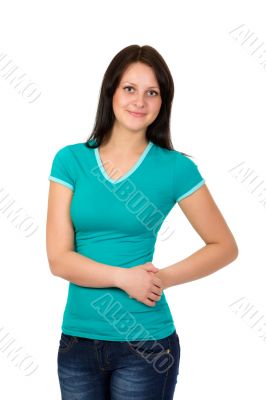 young woman in green t-shirt and blue jeans posing over white