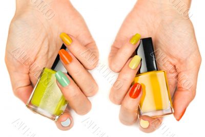 Women`s hands with a colored nail varnish